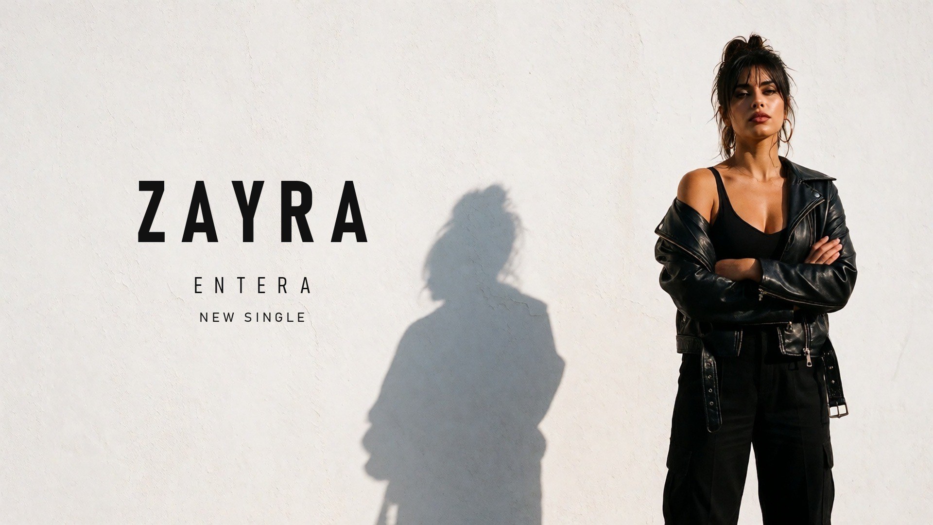 Zayra — Entera key art: the artist against a white wall, title on the left
